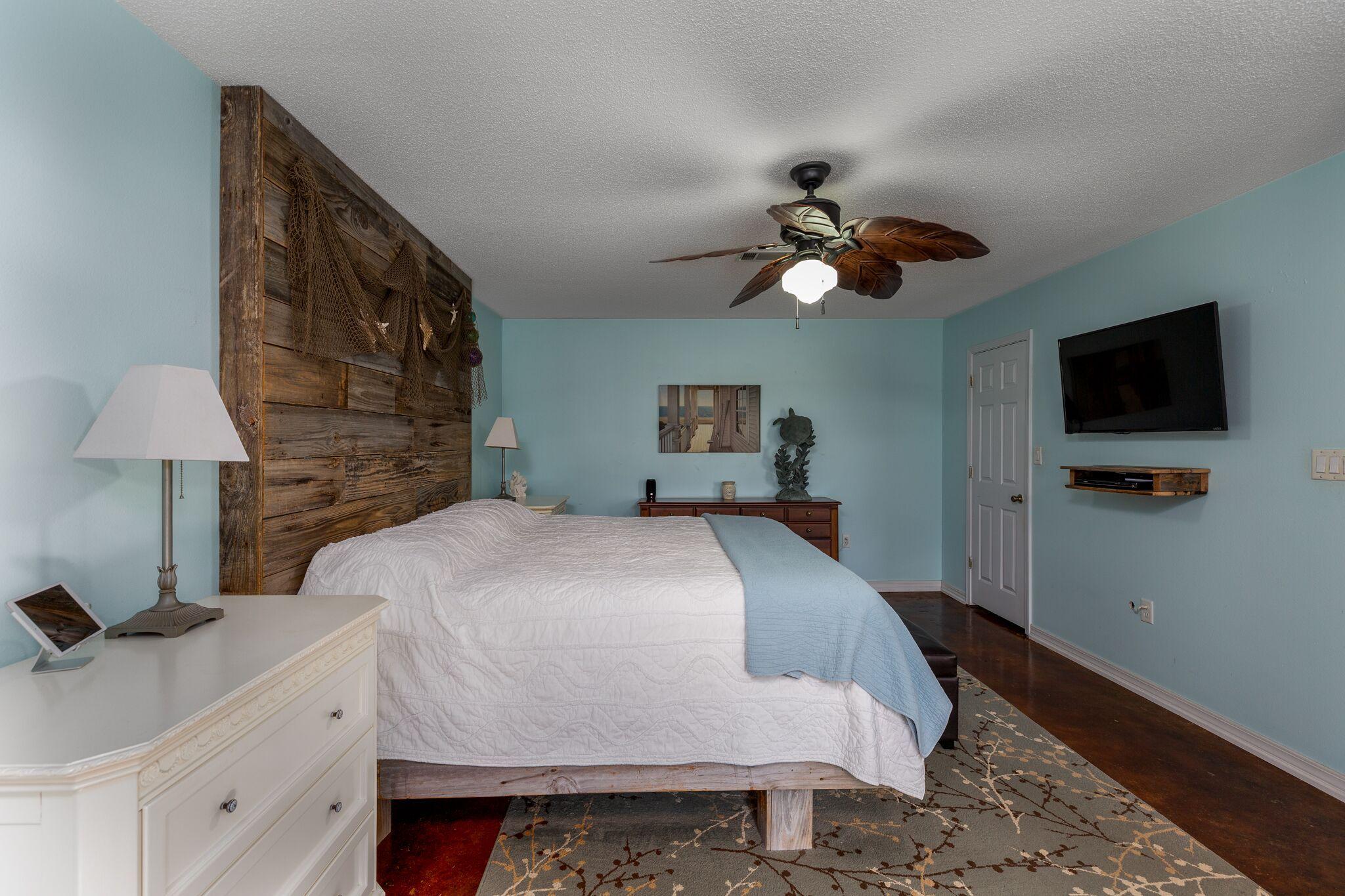 7780 Fenwick Street Navarre, FL 32566 - Photo 12 of 31 a bedroom with a bed and a flat screen tv