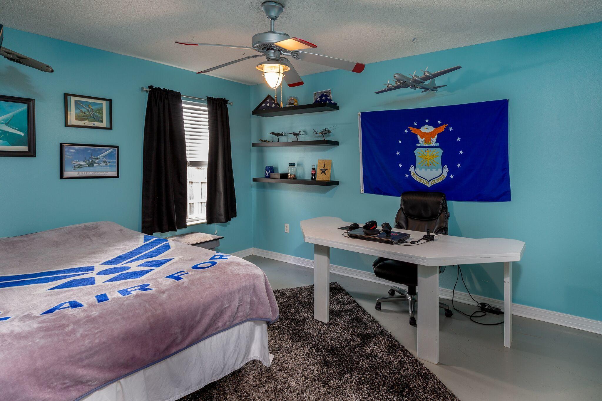7780 Fenwick Street Navarre, FL 32566 - Photo 16 of 31 a bedroom that has a bed and a table in it