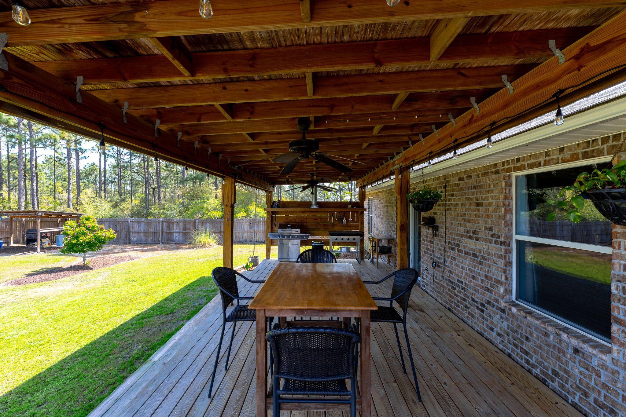 7780 Fenwick Street Navarre, FL 32566 - Photo 20 of 31 a view of a swimming pool with a patio