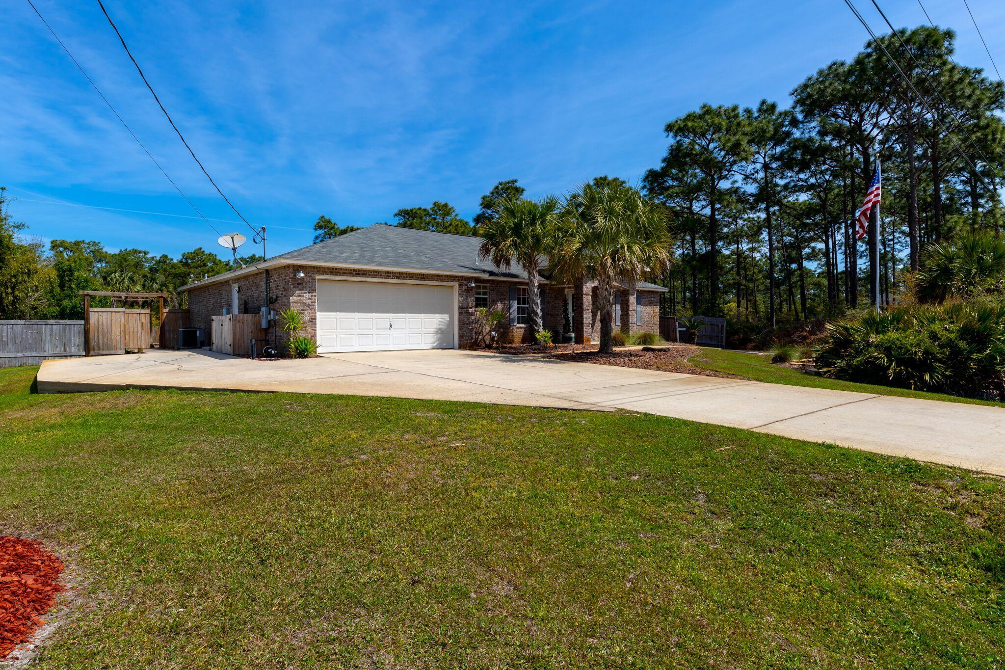 7780 Fenwick Street Navarre, FL 32566 - Photo 2 of 31 a view of a house with a outdoor space