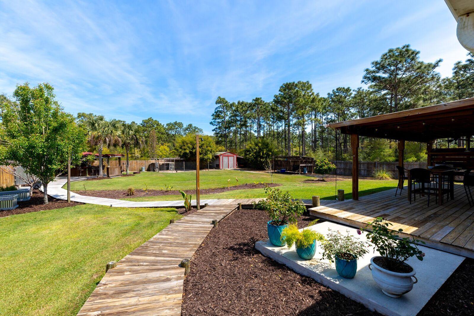 7780 Fenwick Street Navarre, FL 32566 - Photo 22 of 31 a view of a swimming pool with a patio