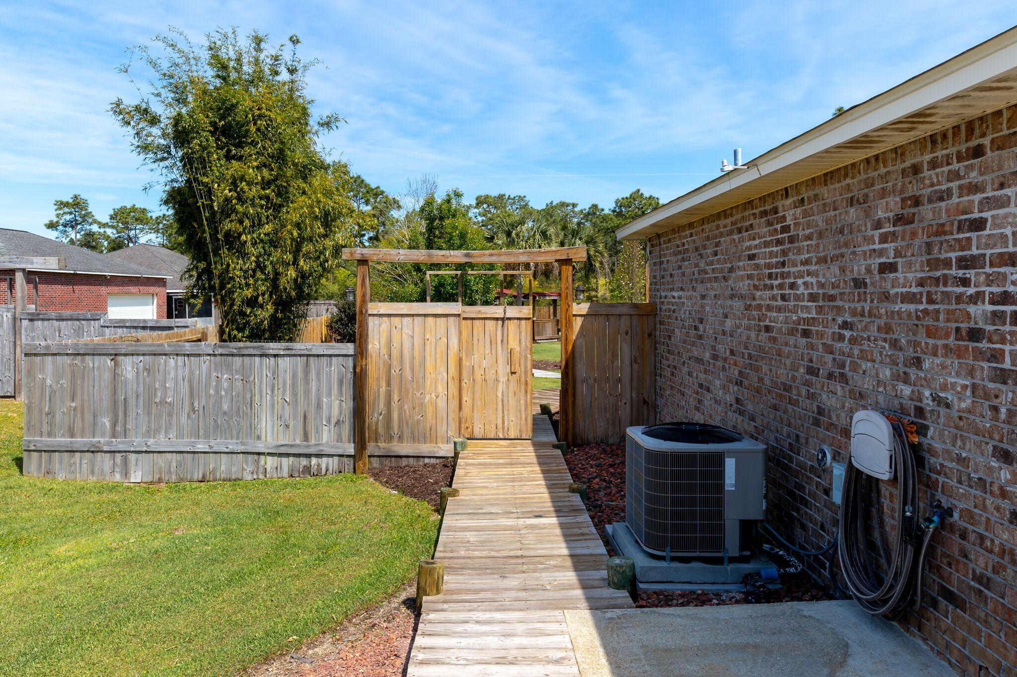7780 Fenwick Street Navarre, FL 32566 - Photo 23 of 31 a backyard of a house with lots of green space