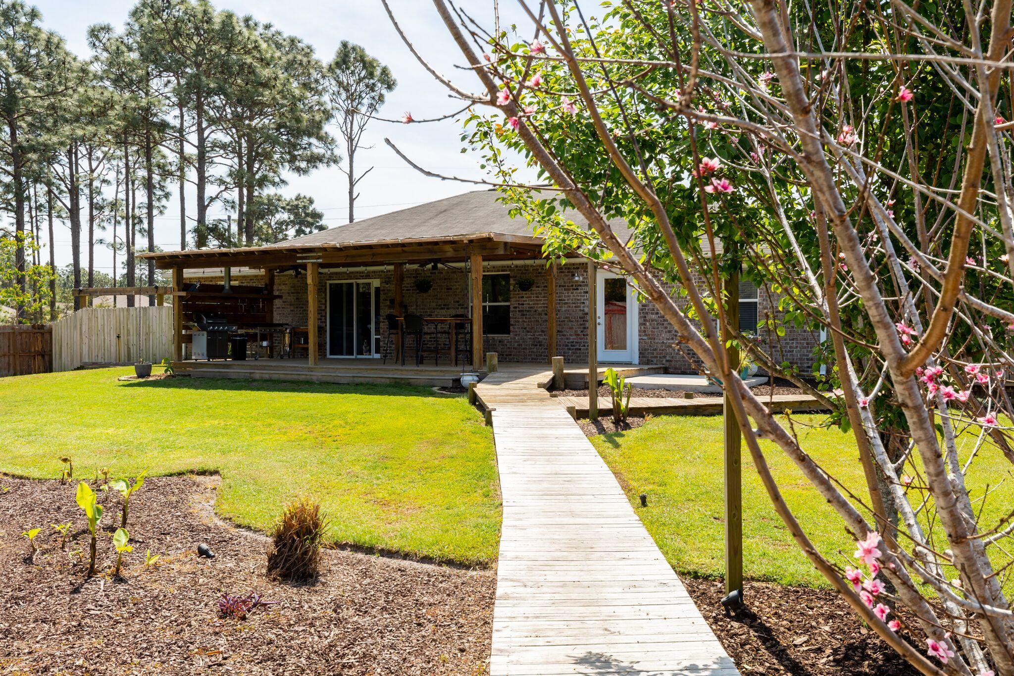 7780 Fenwick Street Navarre, FL 32566 - Photo 29 of 31 a view of a house with swimming pool and porch with furniture