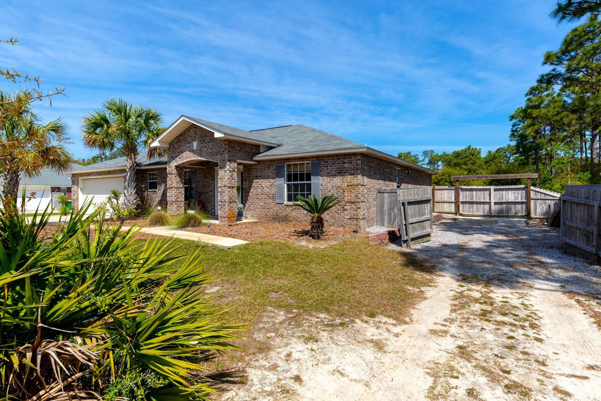 7780 Fenwick Street Navarre, FL 32566 - Photo 30 of 31 a view of a house with a yard