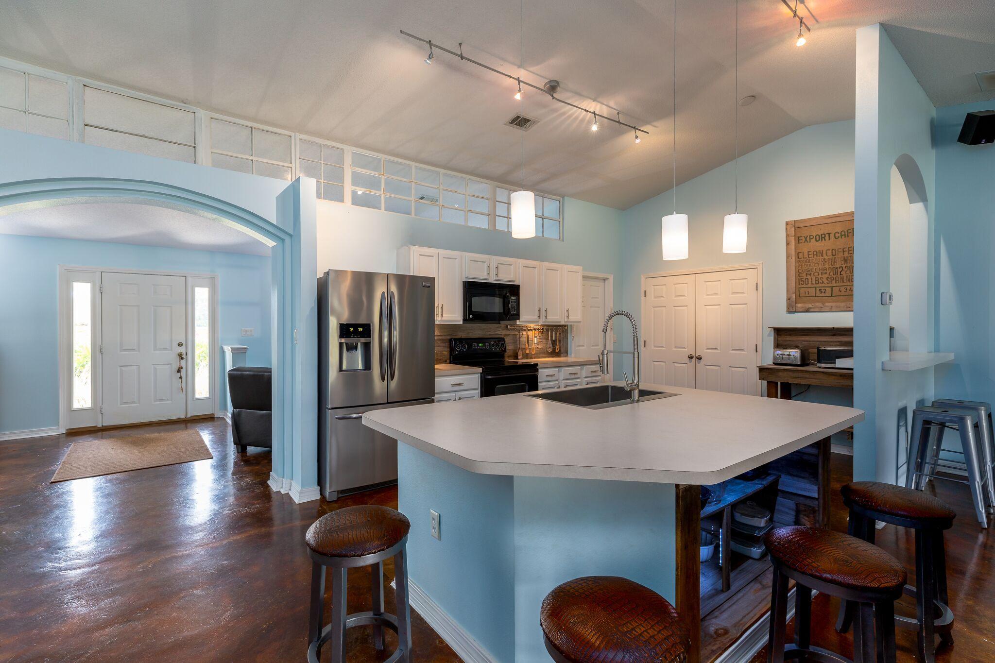 7780 Fenwick Street Navarre, FL 32566 - Photo 6 of 31 a large kitchen with a table and chairs