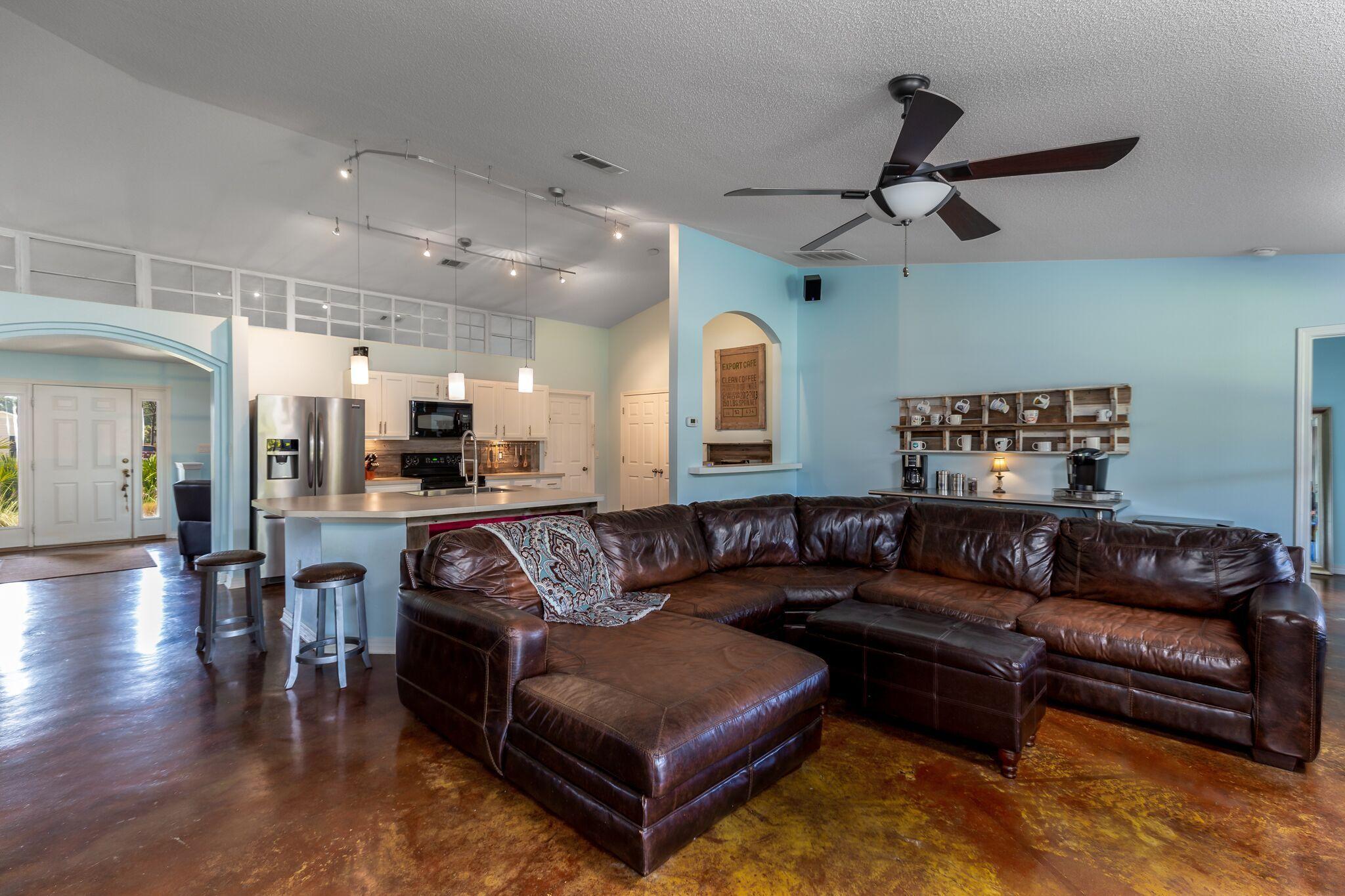7780 Fenwick Street Navarre, FL 32566 - Photo 10 of 31 a living room with furniture and kitchen view