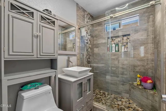 a bathroom with a toilet sink and shower