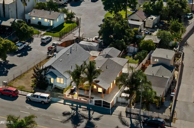an aerial view of multiple houses with yard