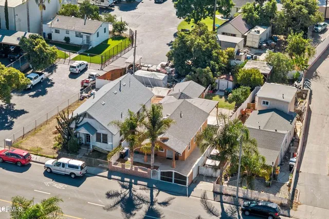 an aerial view of multiple houses with yard