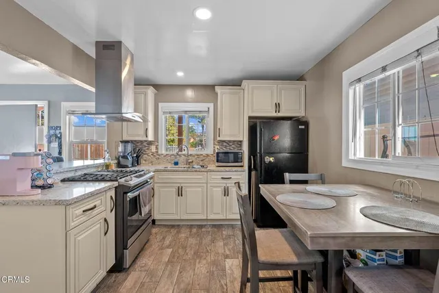 a kitchen with a stove a sink and a refrigerator
