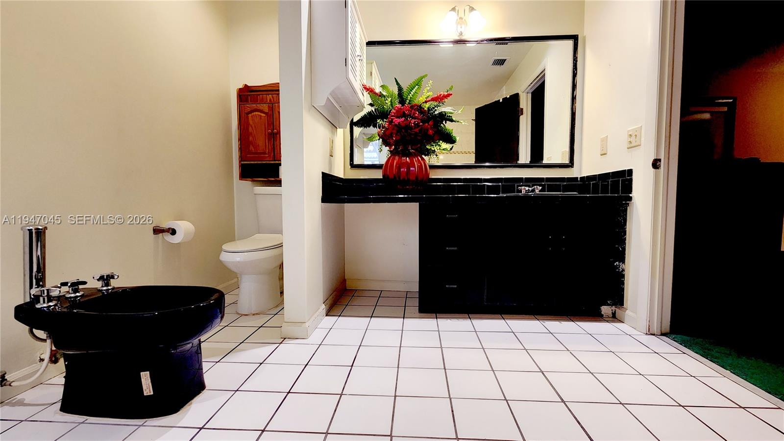 15151 Southwest 166th Street Miami, FL 33187 - Photo 14 of 37 a bathroom with a sink and a mirror
