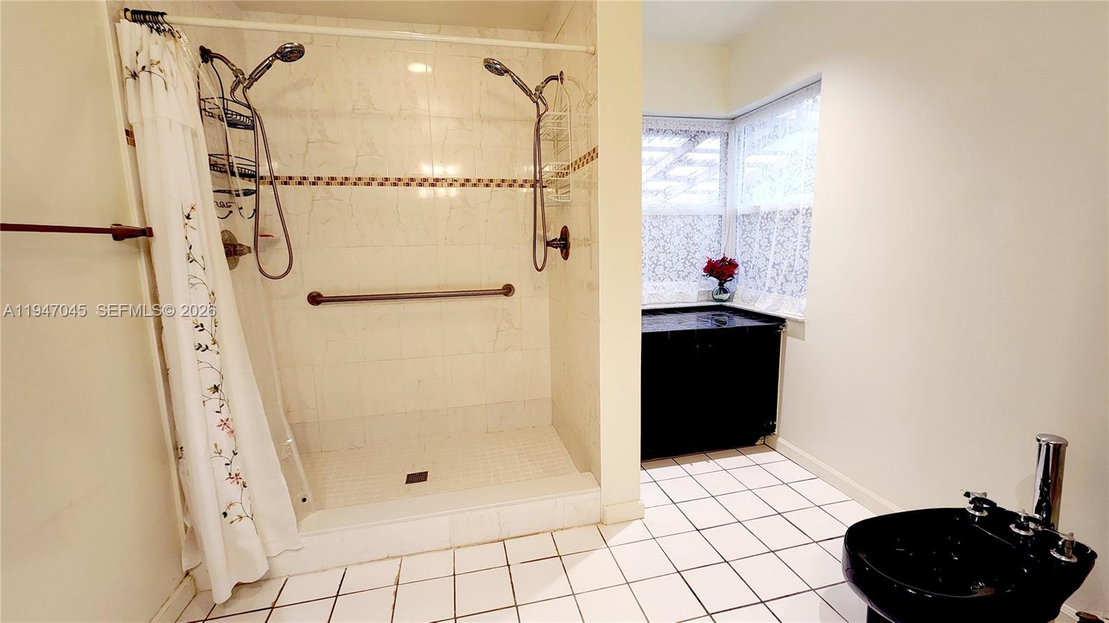 15151 Southwest 166th Street Miami, FL 33187 - Photo 17 of 37 a bathroom with a shower