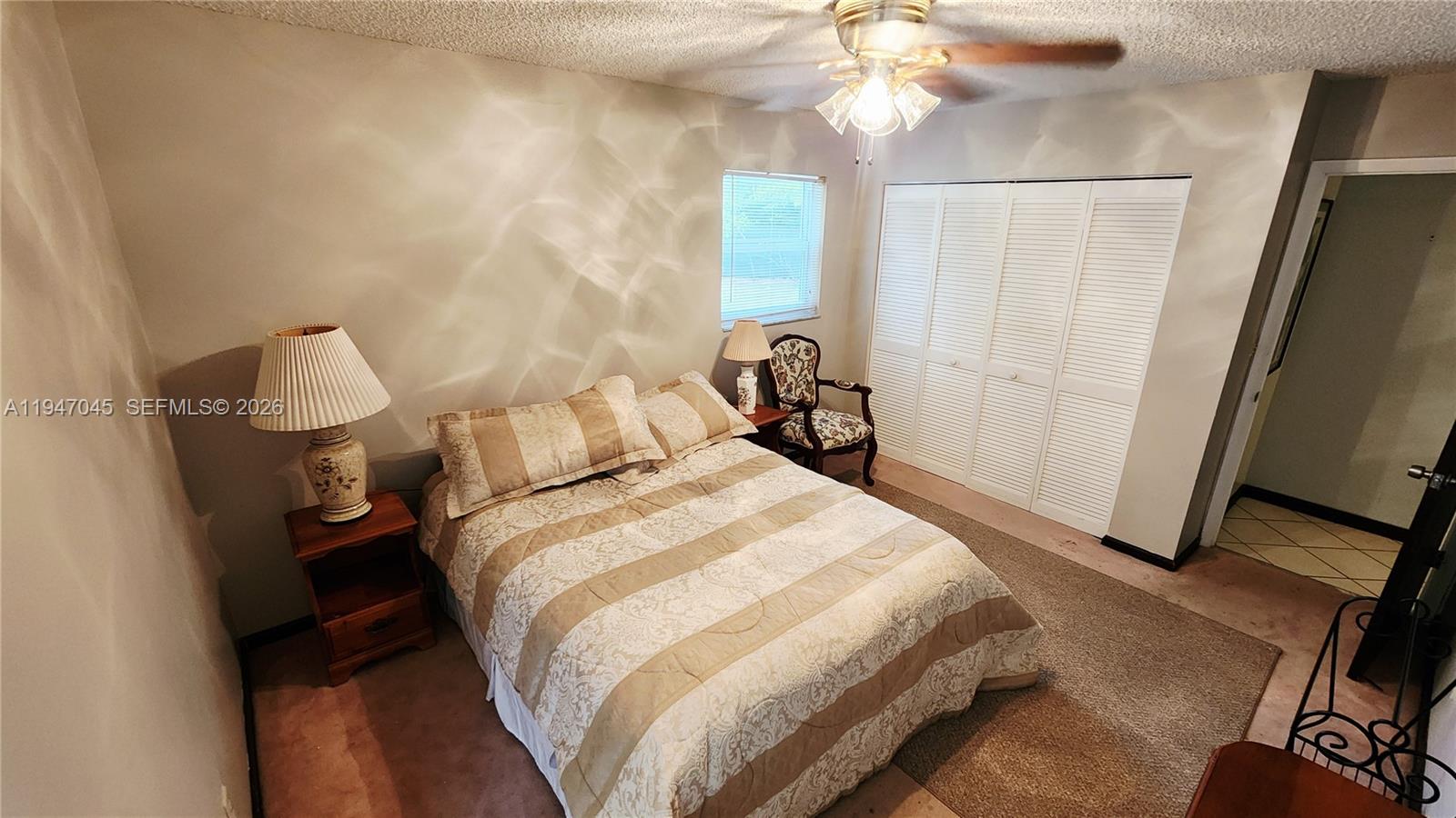 15151 Southwest 166th Street Miami, FL 33187 - Photo 18 of 37 a bedroom with a bed and a mirror