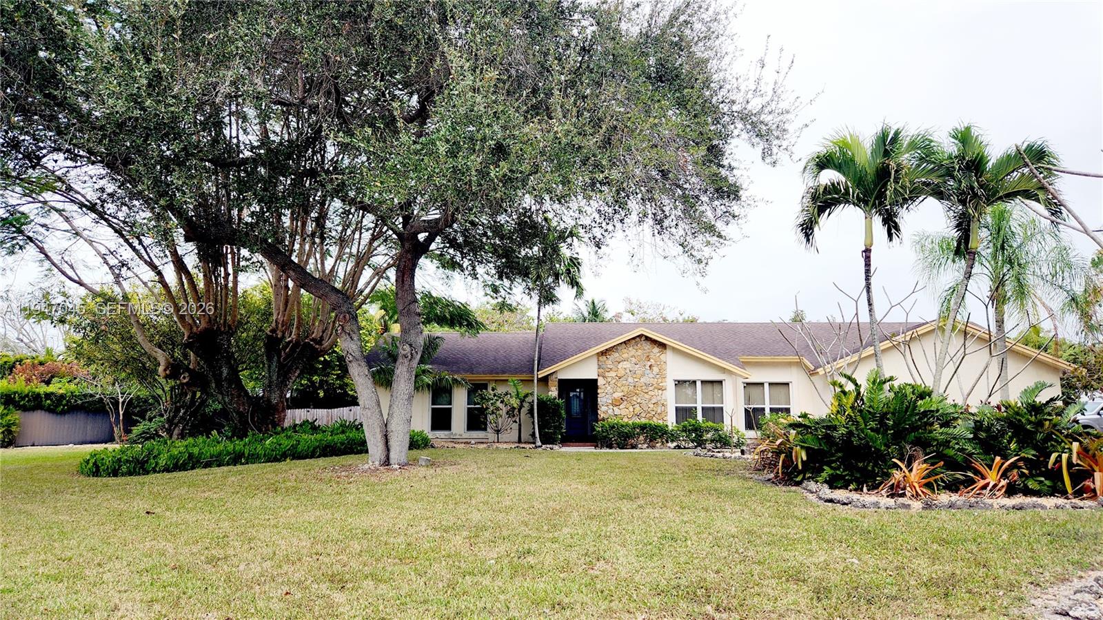 15151 Southwest 166th Street Miami, FL 33187 - Photo 2 of 37 a front view of a house with a yard and potted plants