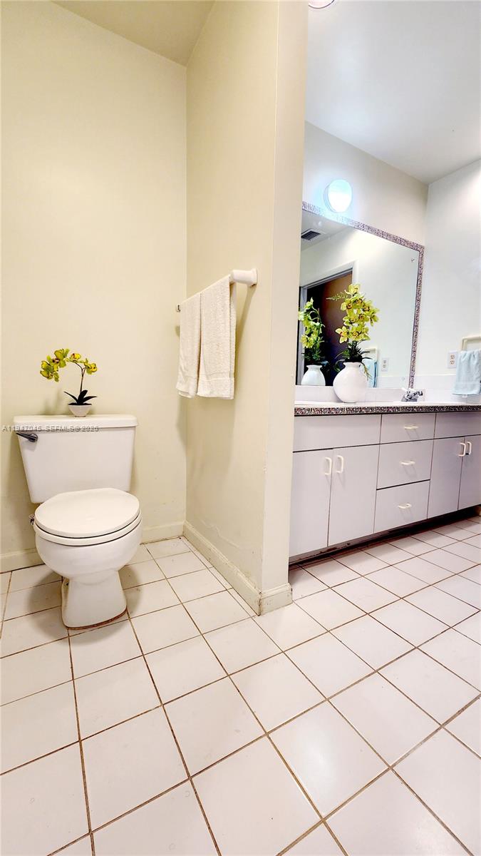 15151 Southwest 166th Street Miami, FL 33187 - Photo 21 of 37 a bathroom with a granite countertop toilet and a sink