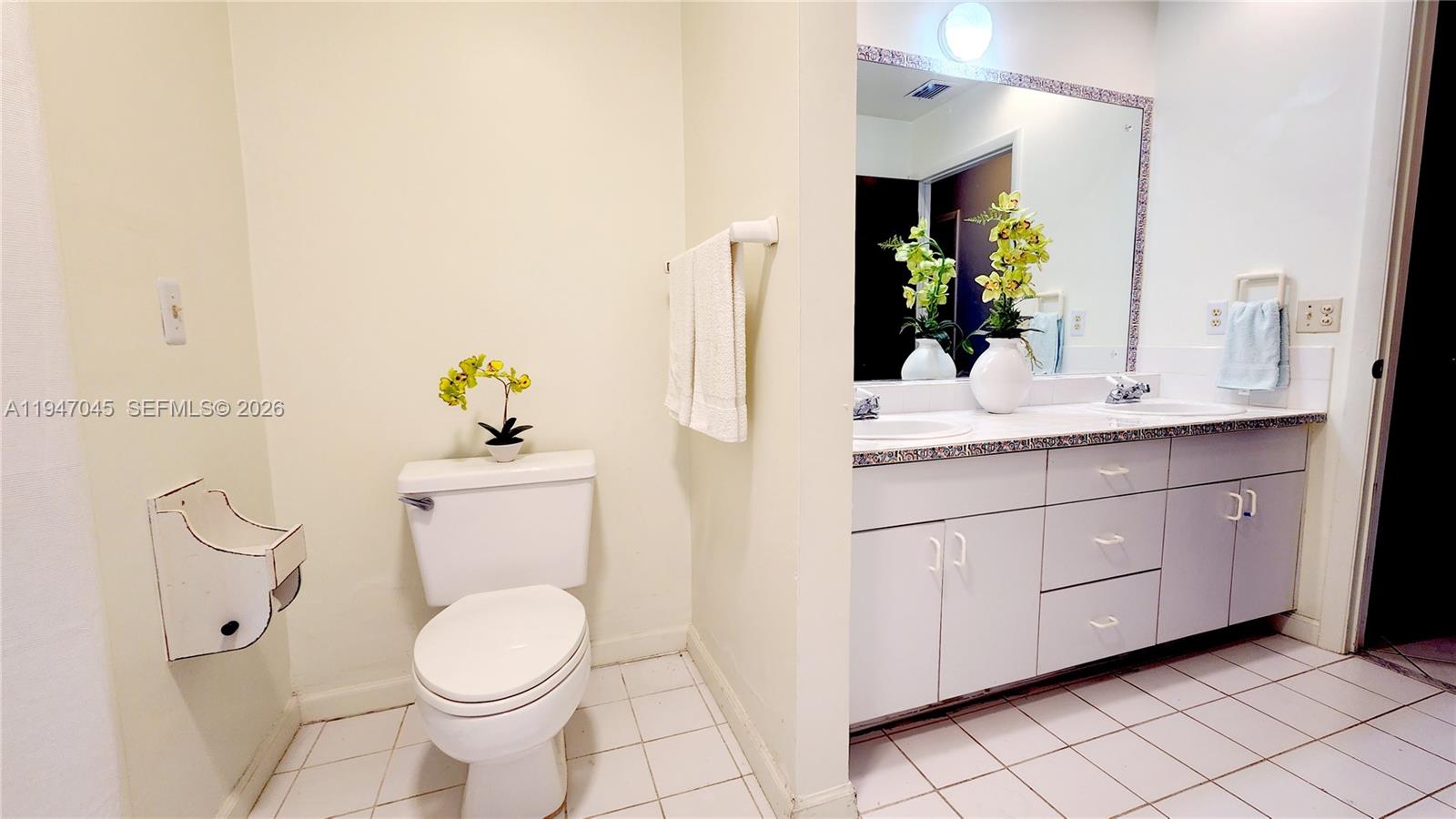15151 Southwest 166th Street Miami, FL 33187 - Photo 22 of 37 a bathroom with a sink vanity and toilet