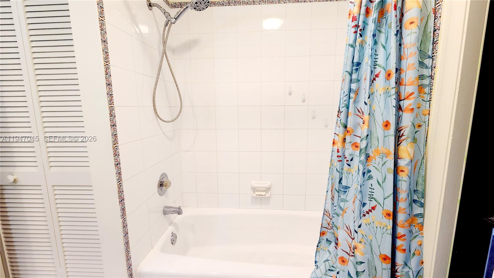 15151 Southwest 166th Street Miami, FL 33187 - Photo 24 of 37 a bathroom with a bathtub and shower curtain