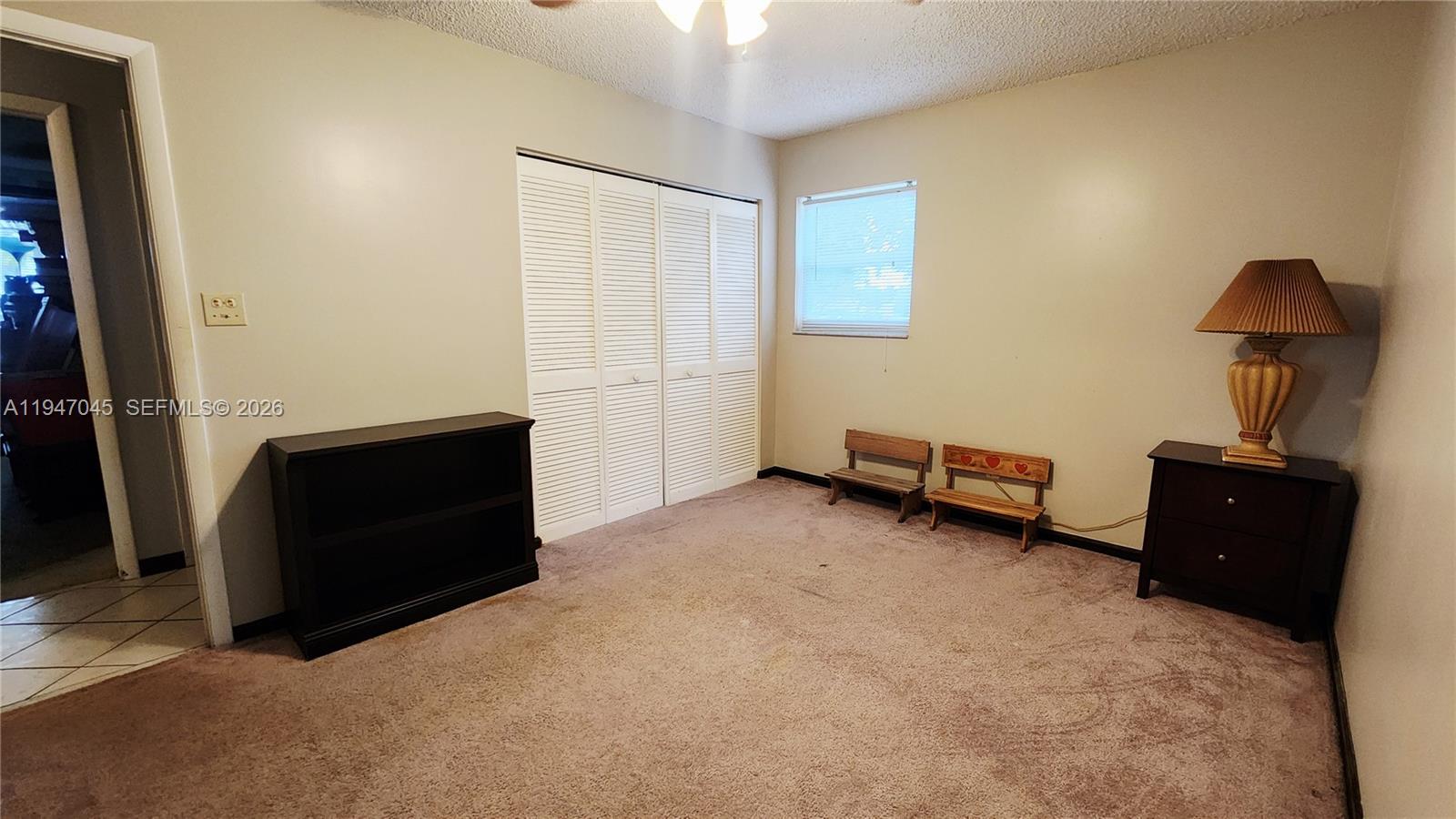 15151 Southwest 166th Street Miami, FL 33187 - Photo 25 of 37 a living room with furniture and a lamp