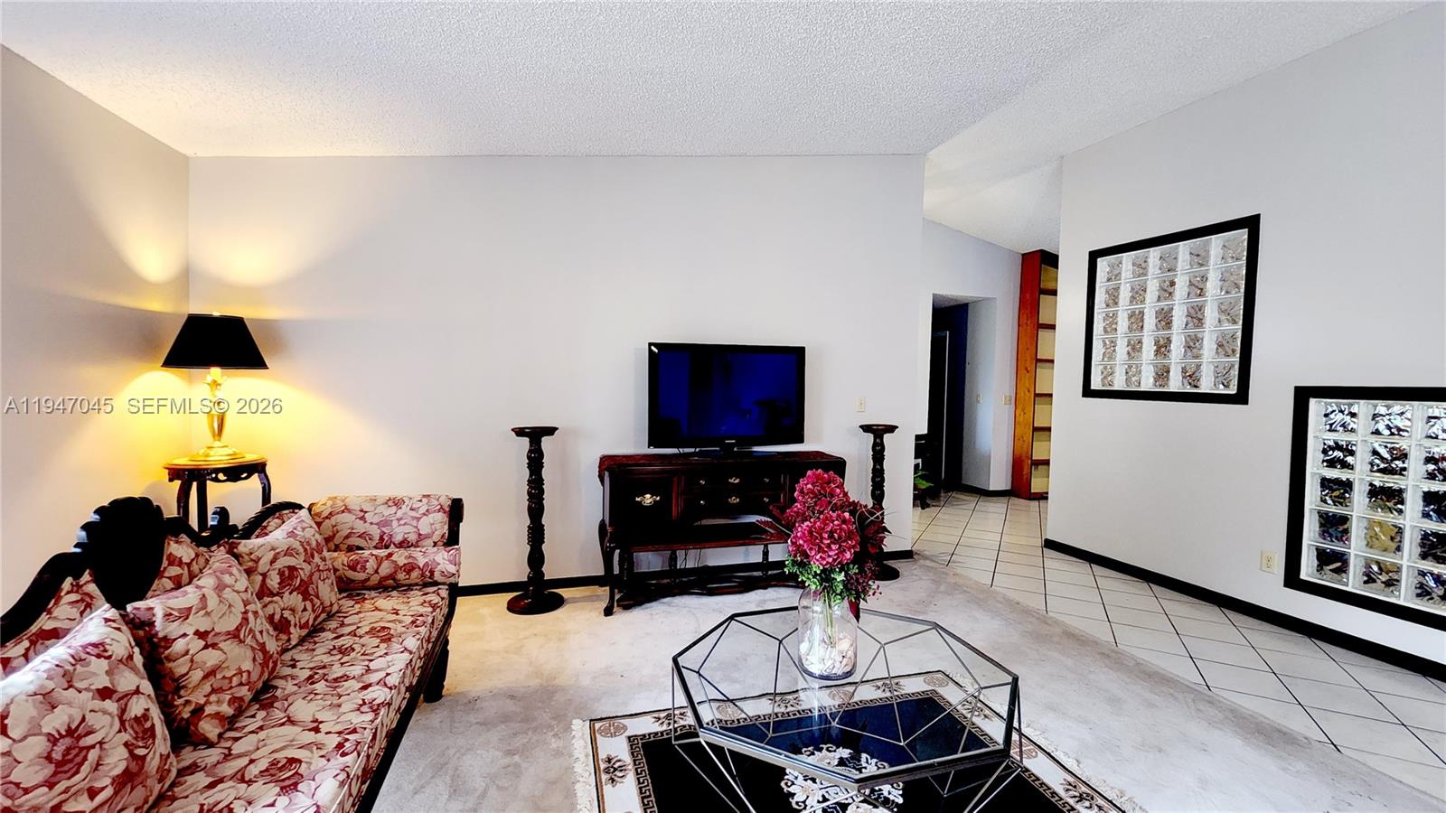 15151 Southwest 166th Street Miami, FL 33187 - Photo 28 of 37 a living room with furniture and a flat screen tv