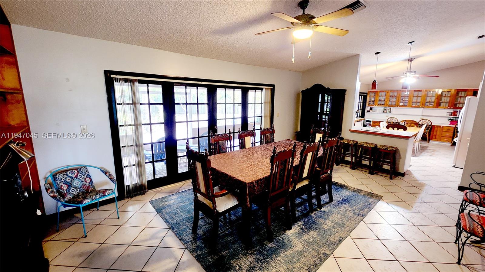 15151 Southwest 166th Street Miami, FL 33187 - Photo 4 of 37 a living room with lots of furniture and a chandelier