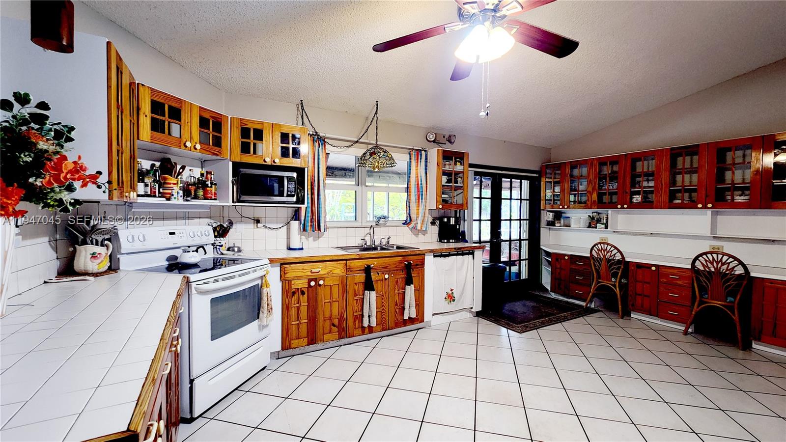 15151 Southwest 166th Street Miami, FL 33187 - Photo 6 of 37 a kitchen with stainless steel appliances granite countertop a stove and a sink