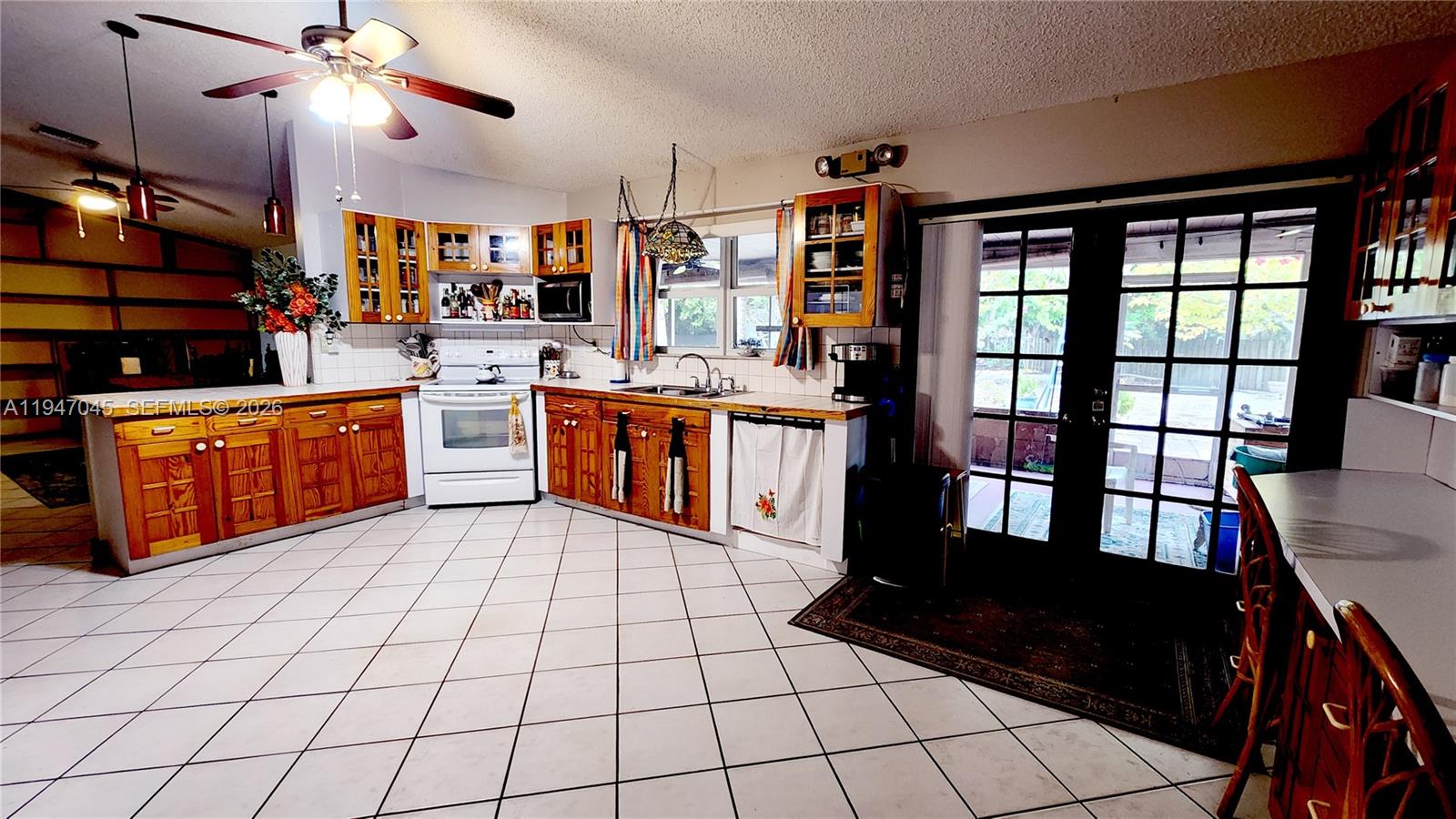 15151 Southwest 166th Street Miami, FL 33187 - Photo 7 of 37 a large kitchen with stainless steel appliances a stove a sink dishwasher and a black cabinets