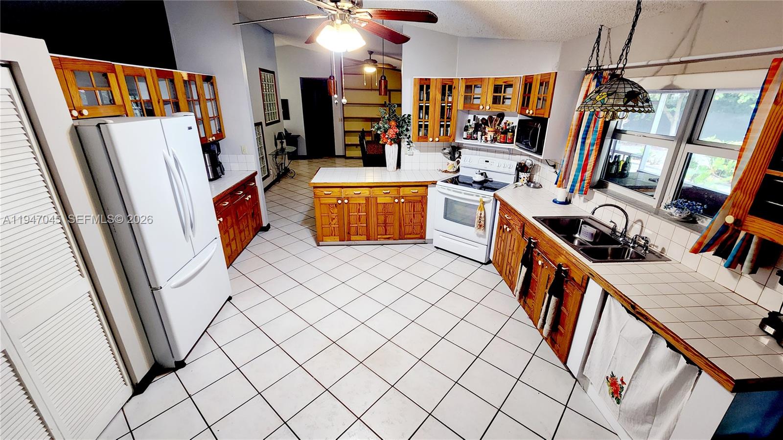 15151 Southwest 166th Street Miami, FL 33187 - Photo 9 of 37 a view of a kitchen with fridge and workspace