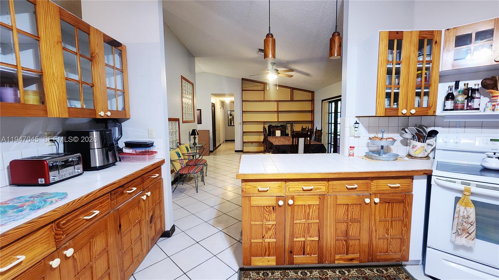 15151 Southwest 166th Street Miami, FL 33187 - Photo 10 of 37 a kitchen with stainless steel appliances granite countertop a sink and cabinets