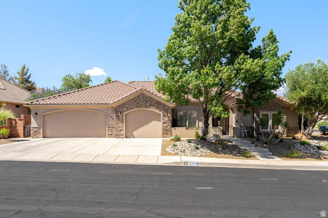 1609 East 10 S Street St. George, UT 84790 - Photo 1 of 68 Stucco exterior featuring stacked stone accents, a tile roof, and an integrated two-car garage