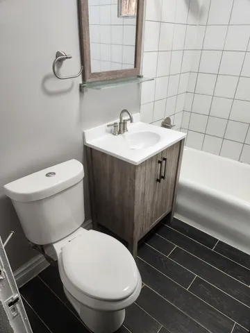 a bathroom with a toilet and a bathtub