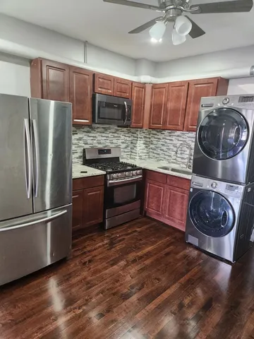 a kitchen with stainless steel appliances granite countertop a refrigerator and a sink