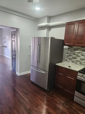 a view of a room with wooden floor and staircase