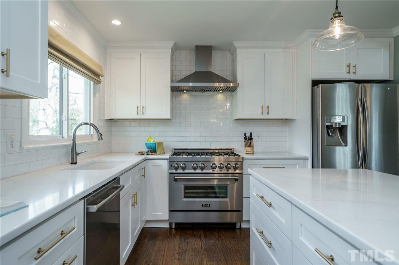 419 East Rowan Street Raleigh, NC 27609 - Photo 11 of 30 a kitchen with stainless steel appliances granite countertop a sink stove and refrigerator