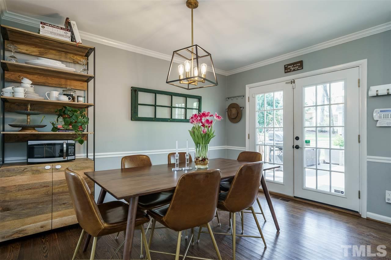 419 East Rowan Street Raleigh, NC 27609 - Photo 13 of 30 a dining room with furniture a chandelier and wooden floor