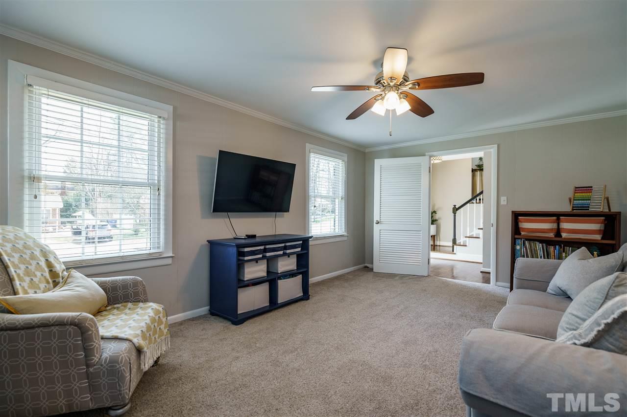 419 East Rowan Street Raleigh, NC 27609 - Photo 15 of 30 a living room with furniture and a flat screen tv
