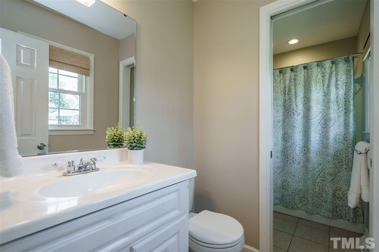 419 East Rowan Street Raleigh, NC 27609 - Photo 18 of 30 a bathroom with a granite countertop sink a toilet and shower