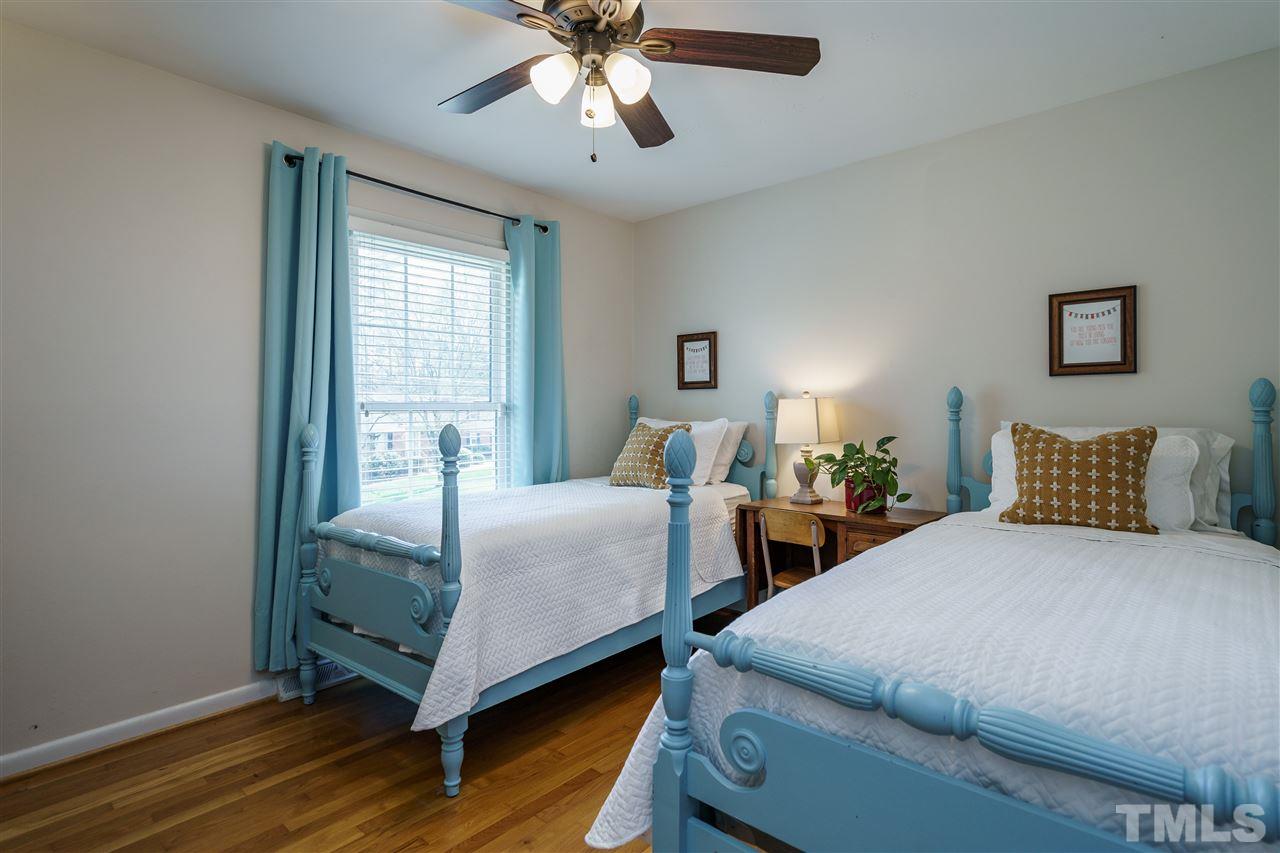 419 East Rowan Street Raleigh, NC 27609 - Photo 19 of 30 a bedroom with two beds and wooden floor