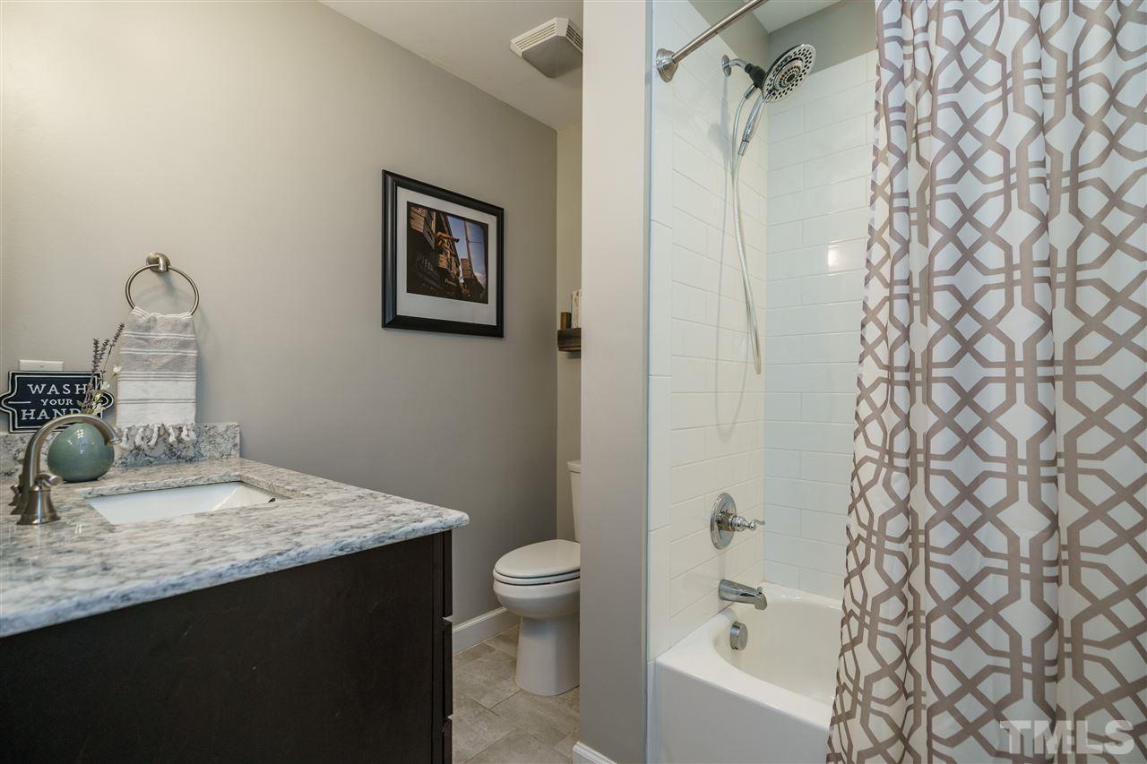 419 East Rowan Street Raleigh, NC 27609 - Photo 20 of 30 a bathroom with a granite countertop sink toilet and shower