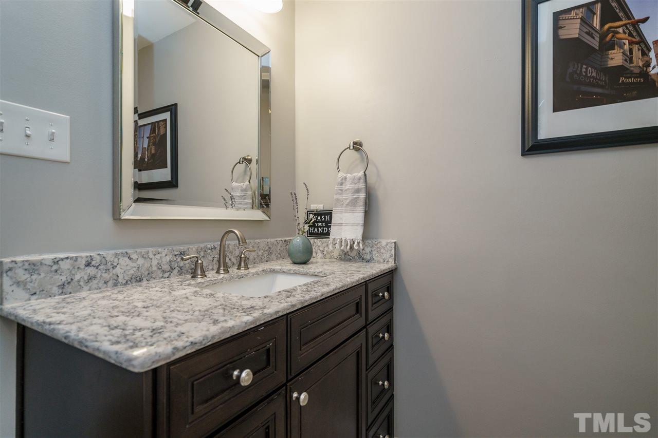 419 East Rowan Street Raleigh, NC 27609 - Photo 21 of 30 a bathroom with a granite countertop sink and a mirror