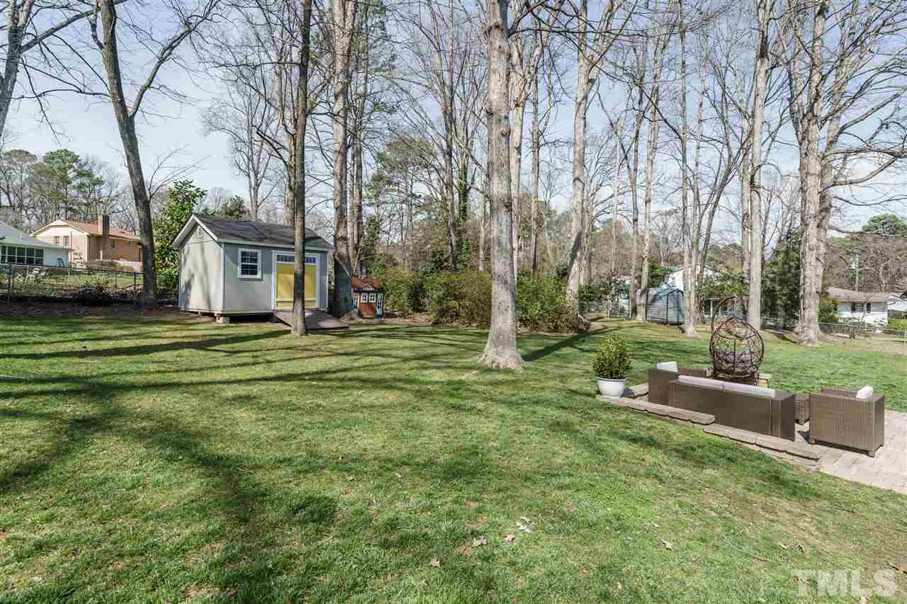 419 East Rowan Street Raleigh, NC 27609 - Photo 29 of 30 a view of a house with a big yard and large trees
