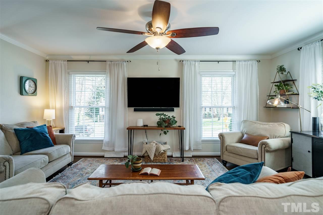 419 East Rowan Street Raleigh, NC 27609 - Photo 5 of 30 a living room with furniture a flat screen tv and a large window