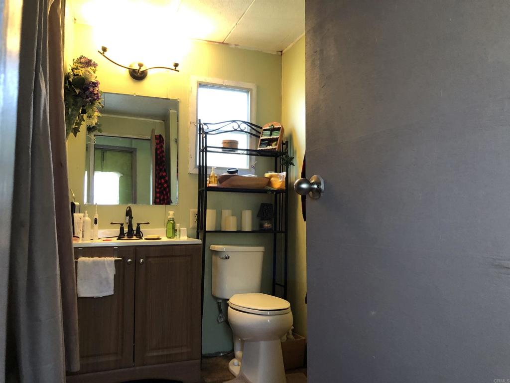 145 East Aviation Road, Unit 22 Fallbrook, CA 92028 - Photo 5 of 7 a bathroom with a sink vanity mirror and toilet