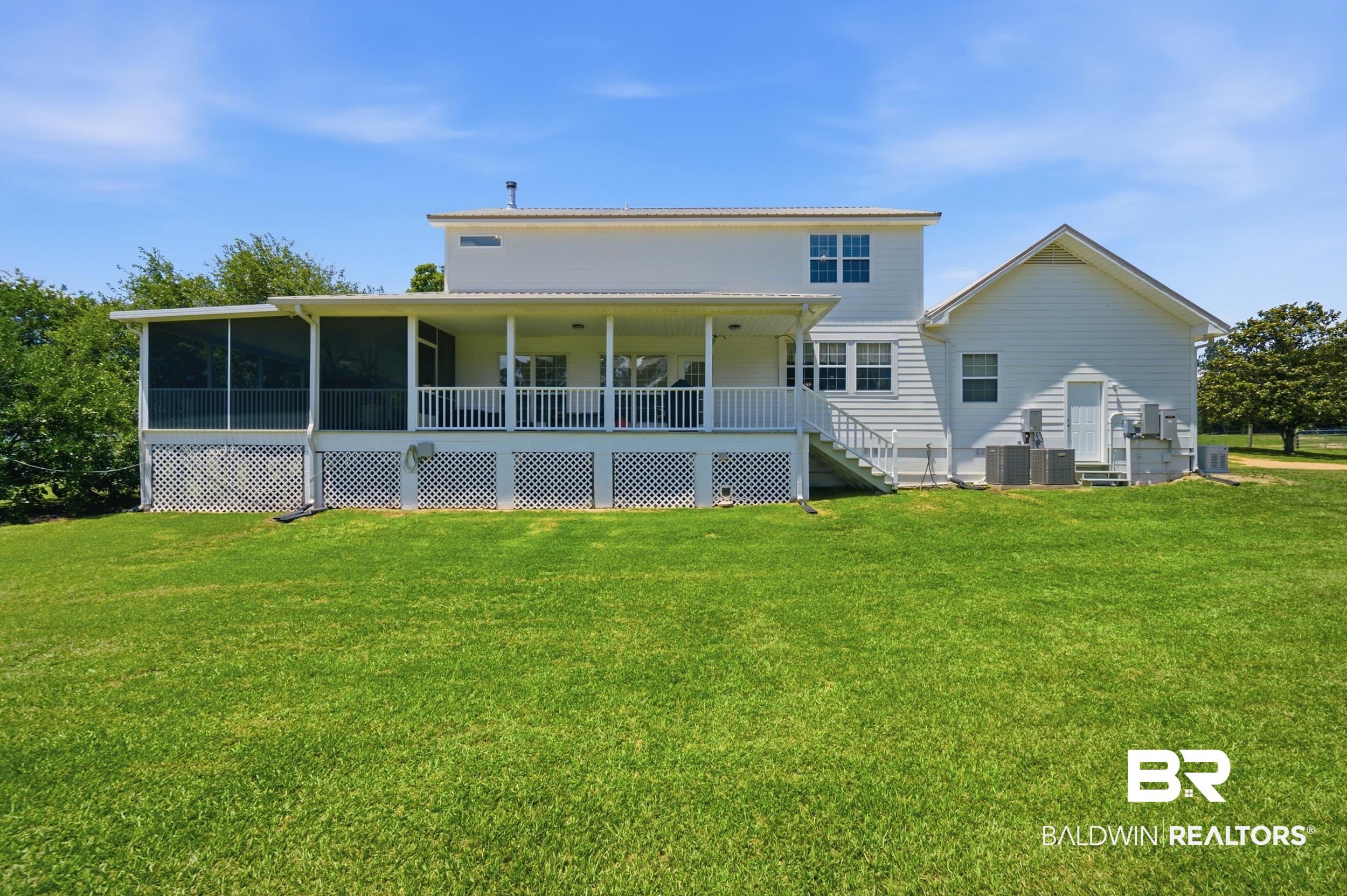 15855 Calvin Richerson Road Bay Minette, AL 36507 - Photo 8 of 83 Rear exterior featuring a screened porch, covered patio, white siding, and a metal roof