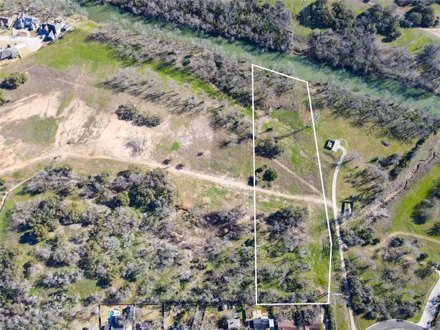 a view of a yard with plants and flowers