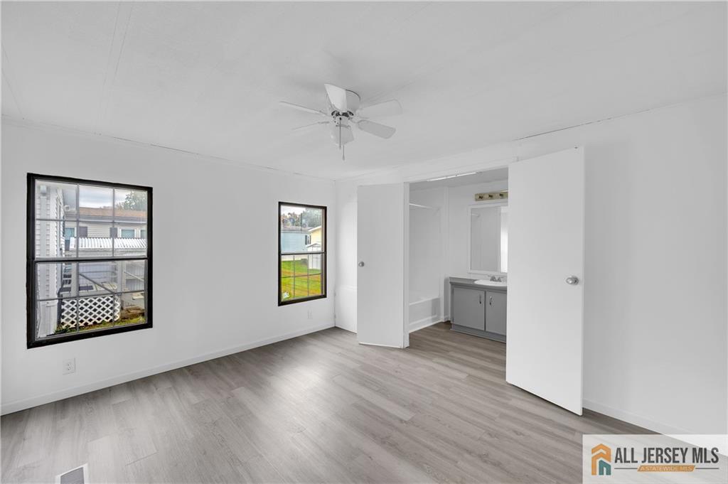 38 Longfellow Road North Brunswick, NJ 08902 - Photo 11 of 23 a view of an empty room with a window and wooden floor