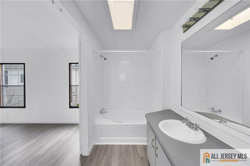 38 Longfellow Road North Brunswick, NJ 08902 - Photo 14 of 23 a bathroom with a tub a sink and a mirror