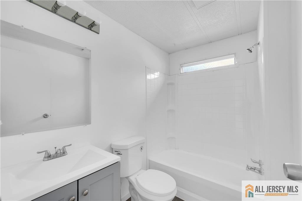38 Longfellow Road North Brunswick, NJ 08902 - Photo 16 of 23 a bathroom with a sink a toilet and shower