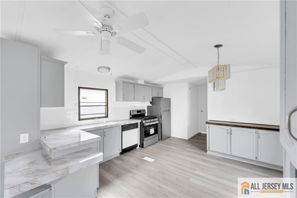 38 Longfellow Road North Brunswick, NJ 08902 - Photo 5 of 23 a kitchen with granite countertop a stove a sink and a refrigerator