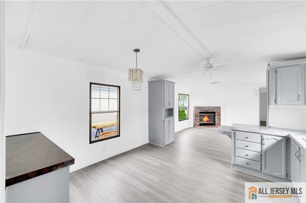 38 Longfellow Road North Brunswick, NJ 08902 - Photo 8 of 23 an empty room with wooden floor fireplace and windows