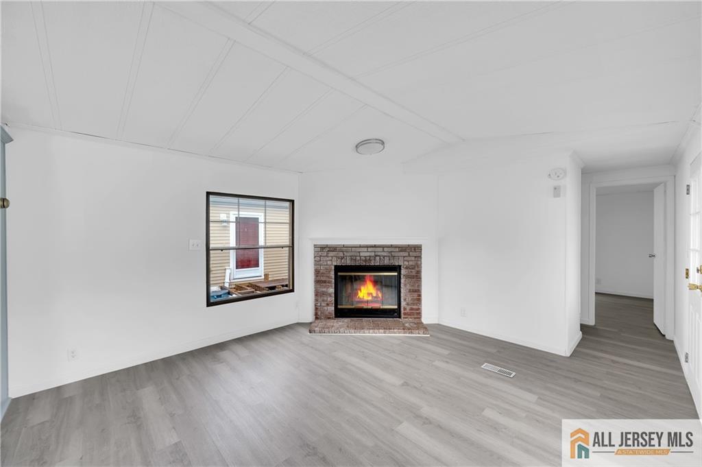 38 Longfellow Road North Brunswick, NJ 08902 - Photo 10 of 23 an empty room with wooden floor fire place and windows